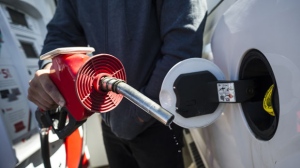 A man fills up his truck with gas in Toronto, on Monday April 1, 2019.The federal government is going around the Manitoba government in order to give carbon tax revenues to the province's schools. Ottawa set aside $60 million from this year's carbon tax revenues to help schools make energy efficiency upgrades to reduce their own carbon footprint and carbon tax costs. THE CANADIAN PRESS/Christopher Katsarov