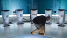 File photo: A technician cleans the set in preparation for the French language leaders debate on September 23, 2015 in Montreal. (THE CANADIAN PRESS/Paul Chiasson)