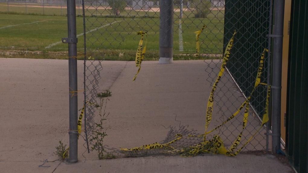 Caution tape up around a hole made in the fence at