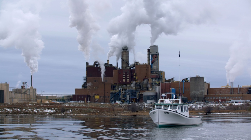 A boat and the Northern Pulp mill in Nova Scotia are shown in a still from the documentary "The Mill."  (THE CANADIAN PRESS/HO)