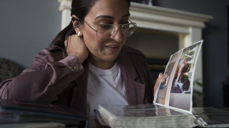 Jessica Sherman looks through pictures of her cousin at her home in Abbotsford, B.C., Wednesday, June 19, 2019. JONATHAN HAYWARD / THE CANADIAN PRESS