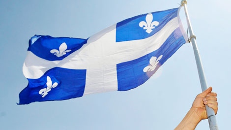 Olivier Racicot holds up a Quebec flag at a rally in Montreal Saturday, June 6, 2009. (Graham Hughes / THE CANADIAN PRESS)
