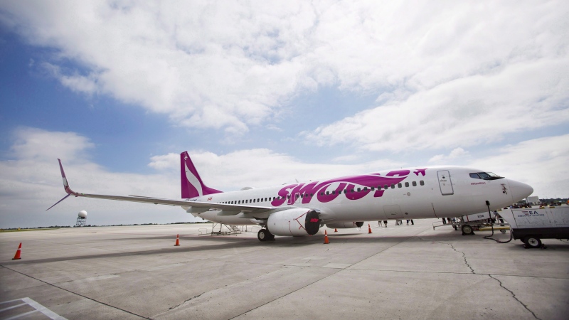 A Swoop Airlines Boeing 737 is on display during their media event, Tuesday, June 19, 2018 at John C. Munro International Airport in Hamilton, Ont. THE CANADIAN PRESS/Tara Walton