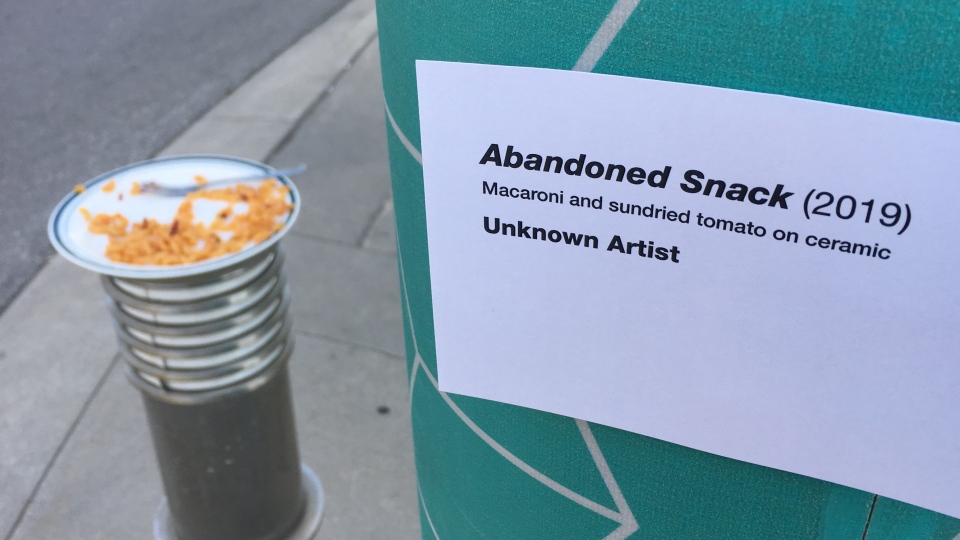A sign next to a plate of abandoned macaroni