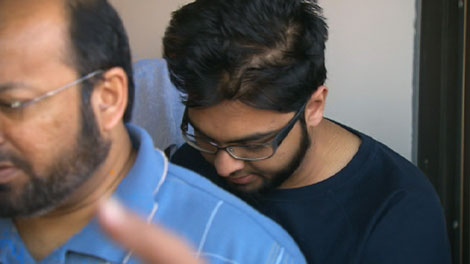 Furqan Muhammad-Haroon leaves court on Wednesday, Aug. 26, 2009, led by his father, Haroon Muhammad. 