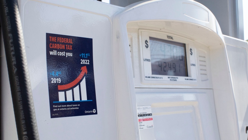A gas pump displays an anti-carbon tax sticker in Toronto on Thursday, August 29, 2019. (THE CANADIAN PRESS/Chris Young)