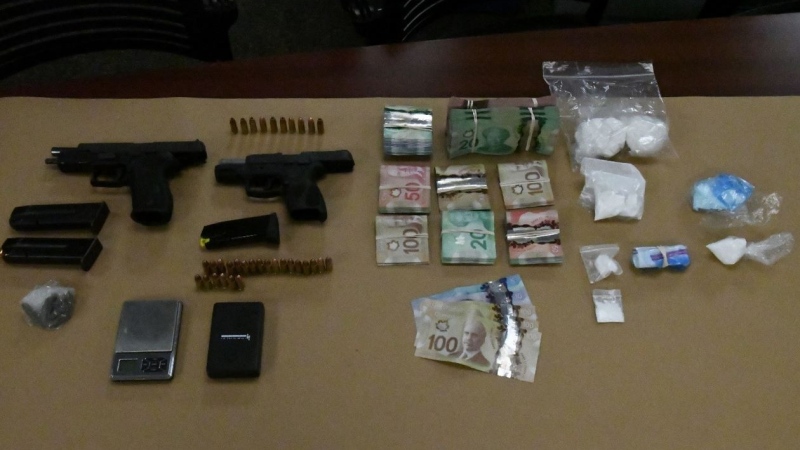 Guns, drugs and cash seized from a residence on Brisbin Street in London, Ont. on Wednesday, Aug. 28, 2019 are seen in this image released by the London Police Service.
