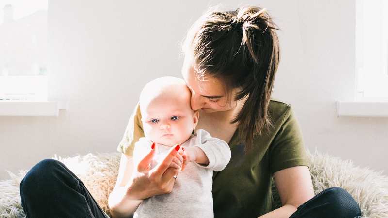 A mom and baby are seen in this stock image. (Daria Shevtsova / Pexels)