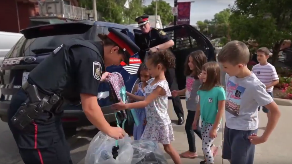 Police deliver backpacks to kids