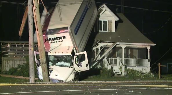 Man charged in transport crash involving house