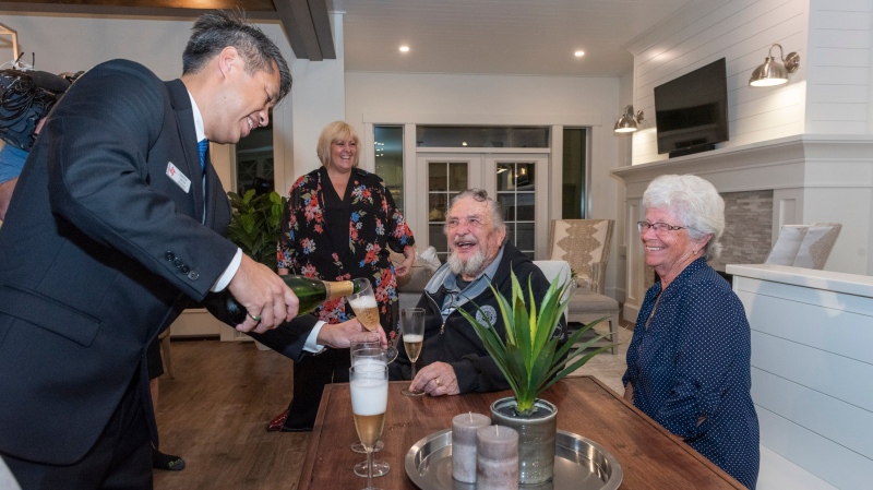 Albert Prendergast of Port Moody, the winner of the 2019 PNE Prize Home Grand Prize Package celebrates in the house with his partner, Maureen Newell, and family. (PNE/Twitter photo)