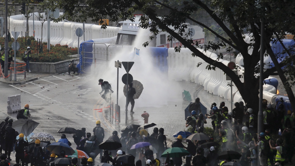 Anti-government protesters sprayed by water cannon