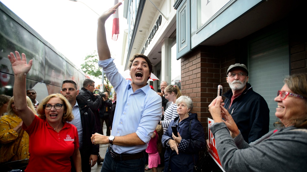 Liberal leader Justin Trudeau raising one hand