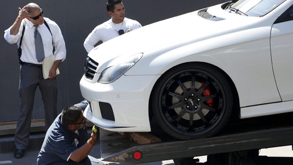 A 2007 Mercedes CL S550, belonging to slain swimsuit model Jasmine Fiore is towed away in West Hollywood, Calif. on Wednesday, Aug. 26, 2009. The car was found in a parking lot next door to a Trader Joe's store on Wednesday. (AP / Damian Dovarganes)