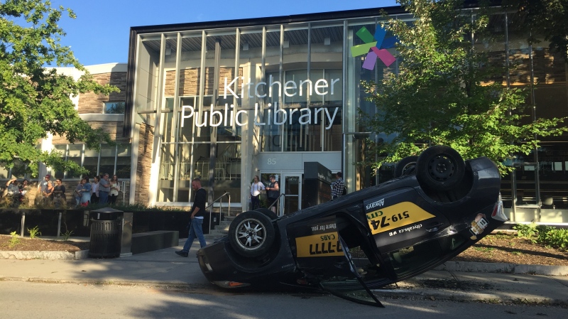 A cab can be seen on its roof just steps from the entrance to the Kitchener Public Library. (Matt Ethier/CTV Kitchener) (Sept. 17, 2019)