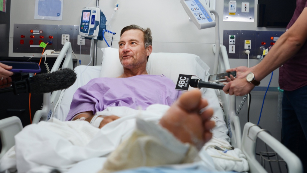 Neil Parker speaking to media from a hospital bed