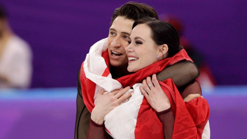 Tessa Virtue and Scott Moir of Canada celebrate during the venue ceremony after winning the gold medal in the ice dance, free dance figure skating final in the Gangneung Ice Arena at the 2018 Winter Olympics in Gangneung, South Korea, Tuesday, Feb. 20, 2018. Canadian ice dancing stars Tessa Virtue and Scott Moir say they are "stepping away" from the sport. THE CANADIAN PRESS/AP-David J. Phillip