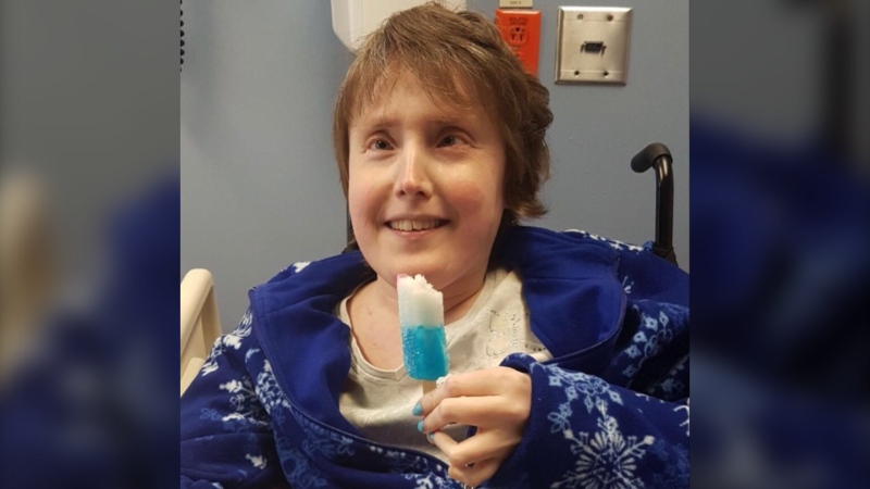 Chrissy Dunnington is seen enjoying a popsicle in hospital in a December 2017 family handout photo. (THE CANADIAN PRESS/HO-Joanne Dunnington)