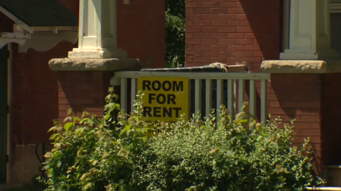 A "room for rent" sign seen  on this building.