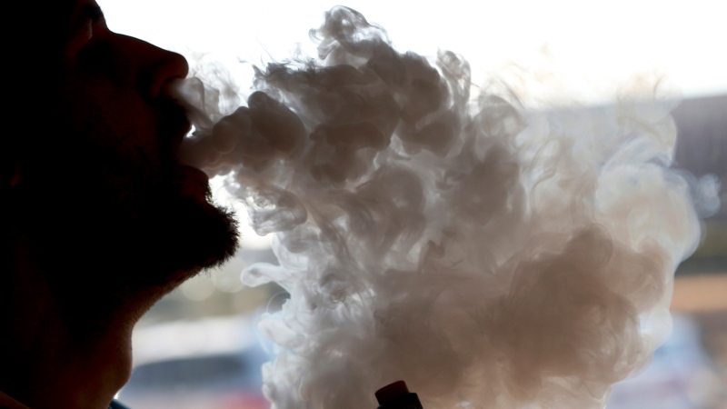 FILE - In this Friday, Jan. 18, 2019 file photo, a man exhales a puff of smoke from a vape pipe at a shop in Richmond, Va. (AP Photo/Steve Helber)