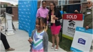 Coriah Feliz holds the key to her family's new home alongside her sister and mother. (CTV News Toronto/Nick Dixon)