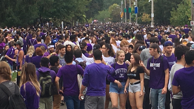 Students gather on Broughdale Avenue near Western University for 'FoCo' celebrations in London, Ont. on Saturday, Sept. 28, 2019. (Brent Lale/CTV London)