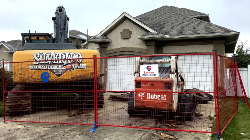 Heavy machinery poised to demolish a home located in an upscale Saskatoon neighborhood. (Dale Cooper/CTV Saskatoon)