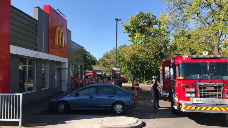Firefighters work at the scene of a fire at a McDonald's restaurant in London, Ont. on Tuesday, Oct. 1, 2019. (Sean Irvine / CTV London)
