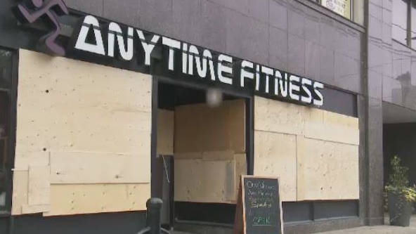 Owners of Anytime Fitness were cleaning up Tuesday after it's windows were damaged overnight.