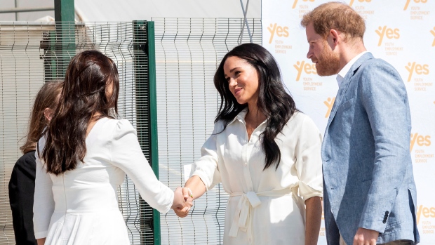 Prince Harry and Meghan, Duchess of Sussex visit a Youth Employment Services Hub in Makhulong, Tembisa, a township near Johannesburg, South Africa, Wednesday Oct. 2, 2019. (AP Photo/Christiaan Kotze)