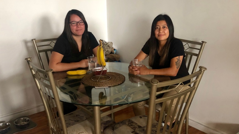 Danna Morales, right, sits at home with her partner Francis Mena.(Natalie Johnson/CTV News Toronto)