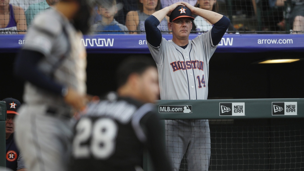 Houston Astros manager AJ Hinch, right