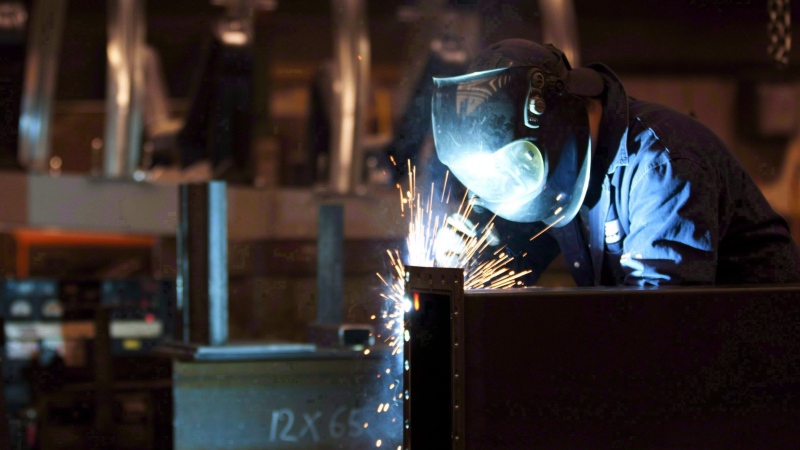 A welder works in a factory in Quebec City, Tuesday, February 28, 2012. THE CANADIAN PRESS/Jacques Boissinot