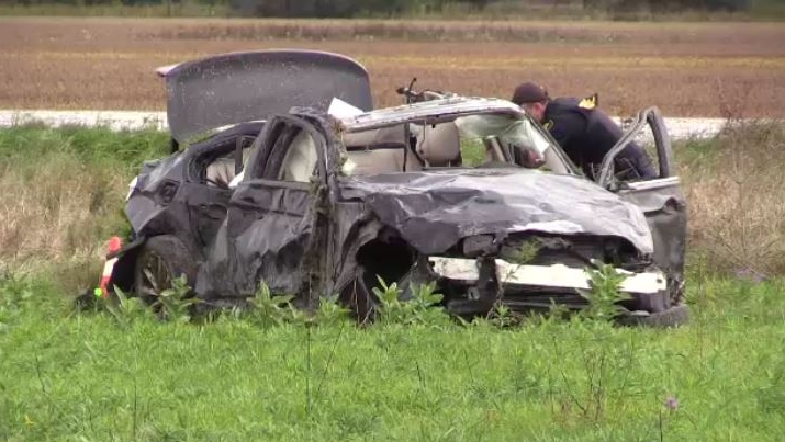 An OPP officer works at the scene of a crash that left three people dead in Oil Springs, Ont. on Friday, Oct. 4, 2019. (Gerry Dewan/CTV News London)