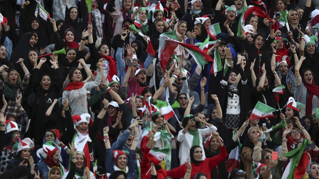 Iranian women cheer at the Azadi Stadium in Tehran