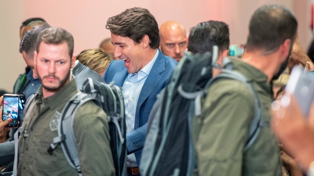 High profile security surrounds Liberal Leader Justin Trudeau as he arrives at a rally in Mississauga, Ont., Saturday, Oct. 12, 2019. The Rally was delayed for 90 minutes due to a security issue. THE CANADIAN PRESS/Frank Gunn