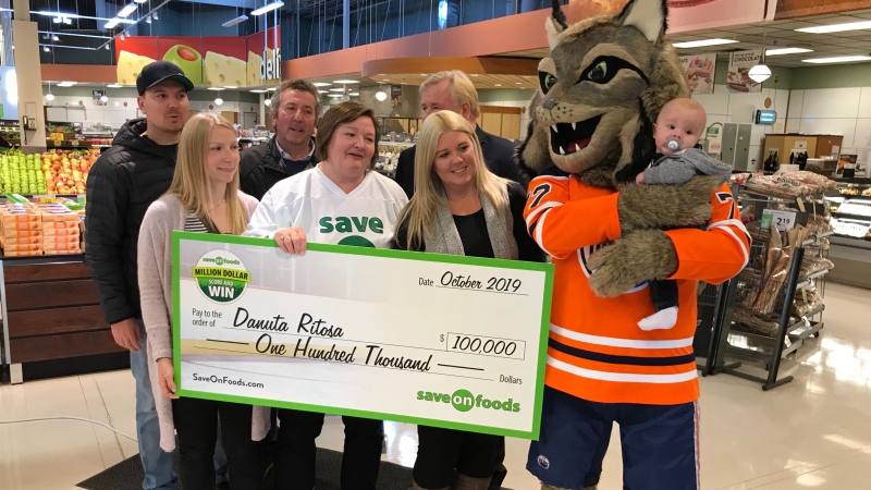 Edmonton's Danuta Ritosa accepted a $100,000 cheque after winning Save-On-Foods' Million Dollar Score and Win contest. Oct. 16, 2019. (CTV News Edmonton)