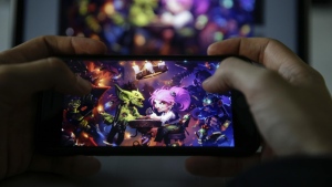 The game "Hearthstone" is seen on a smartphone in this 2018 photo. Video game company Activision Blizzard suspended three American University esports players for six months after they held up a "Free Hong Kong, boycott Blizz" sign during their championship match last week. (CNN via Metin Aktas/Anadolu Agency/Getty Images)