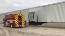 Damage to an industrial building from a truck crash is seen in Exeter, Ont. on Thursday, Oct. 17, 2019. (@OPP_WR / Twitter)