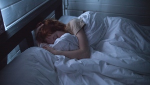 A woman is seen sleeping in this file photo. (Ivan Oboleninov / Pexels)