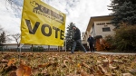 Voters make their way to cast their vote in Edmonton Alta, on Monday, October 21, 2019. THE CANADIAN PRESS/Jason Franson 