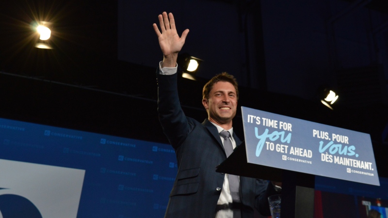 Conservative candidate Michael Kram waves to the crowd at Conservative Election Headquarters after beating out Liberal MP Ralph Goodale in the Regina-Wascana riding. (Brendan Ellis/CTV News)
