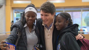 Newly re-elected Prime Minister Justin Trudeau takes selfies with commuters in the Montreal Metro.
