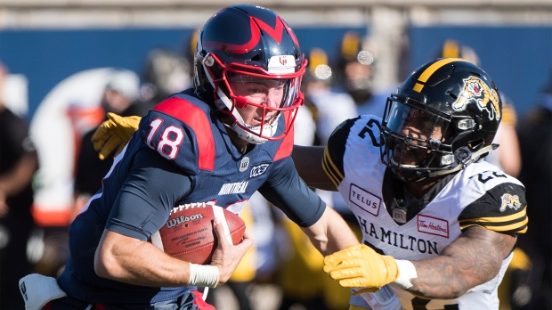 Montreal Alouettes quarterback Matthew Shiltz (18) is tackled by Hamilton Tiger-Cats' Justin Tuggle (22) during second half CFL football action in Montreal, Saturday, Oct. 25, 2019. THE CANADIAN PRESS/Graham Hughes
