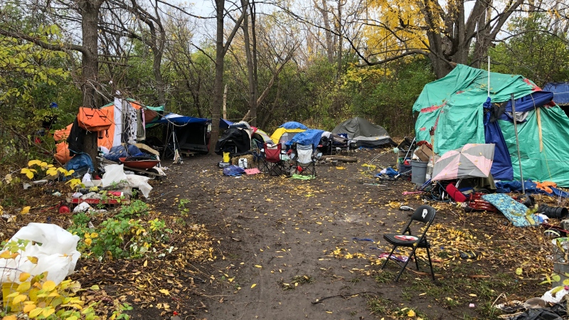 More than a dozen people, left homeless in a rooming house fire, are now living in a 'tent city' in a wooded-area behind the OTrain’s Bayview Station.