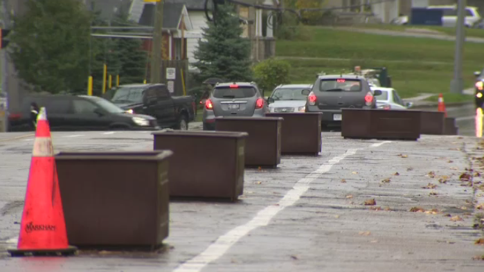 Flower boxes being tested as a solution to separate bike lanes from drivers.