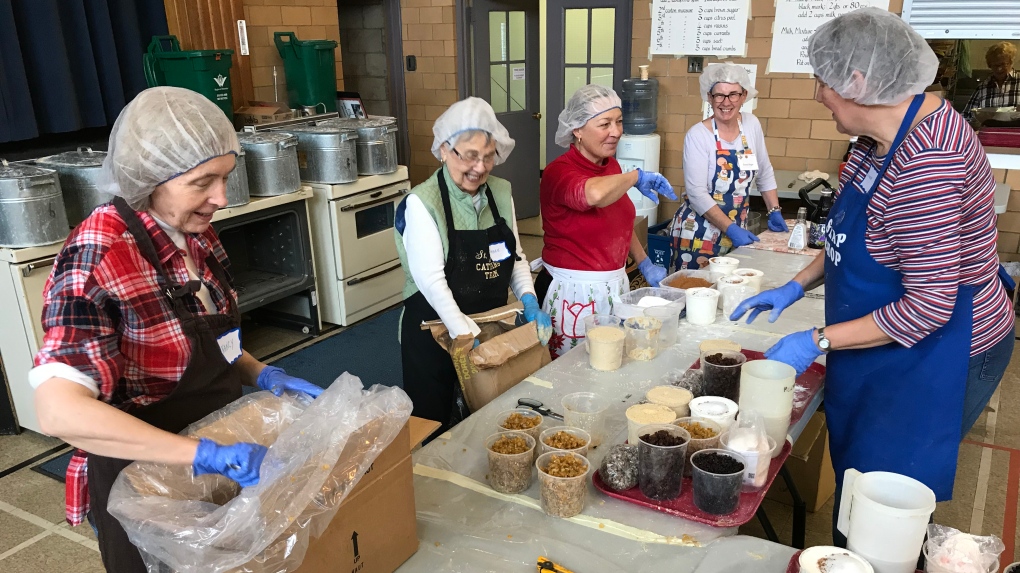 Volunteers making Christmas pudding