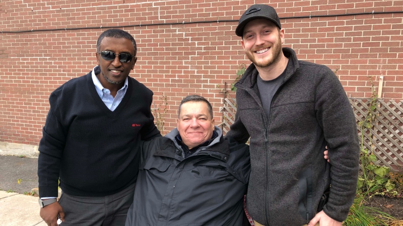 Chris MacMillan (center) got to thank his 'guardian angels' Mohammed Omer (left) and David Brousseau-Lambert (right) who helped him catch his much needed bus ride.