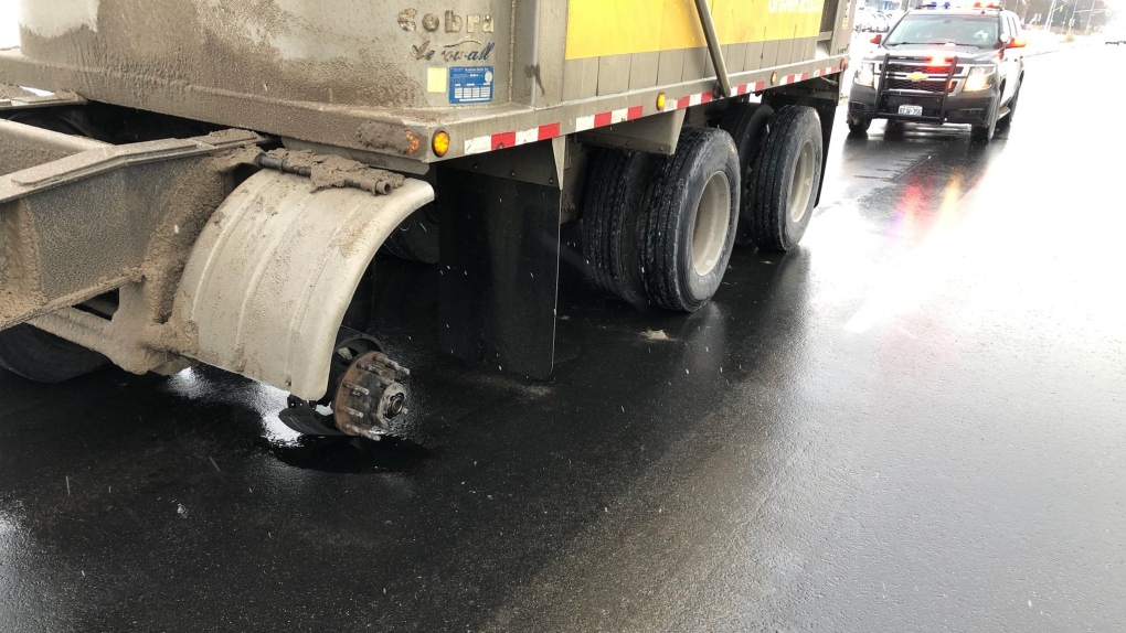 Tire flies off transport truck 