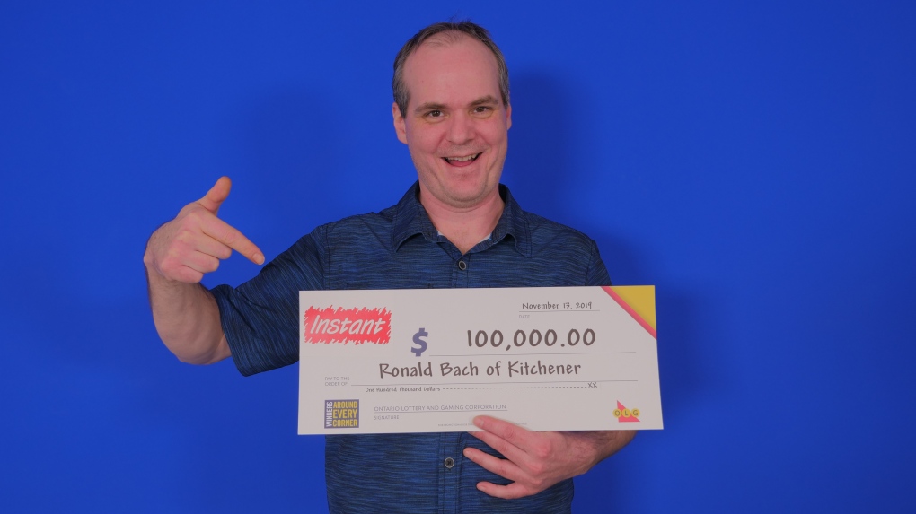 Ronald Bach holding a lottery winning cheque